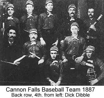 IMAGE/PHOTO: Cannon Falls Baseball Team 1887: Black and white photo of the Cannon Falls 1887 baseball team in uniforms of the time with white flat-topped painter's style caps sporting dark horizontal stripes, and white crossover neckties over dark shirts and pants; some holding bats or other equipment. Dick Dibble stands in the back row, 4th. from left, wearing a bushy handlebar moustache and staring straight ahead.