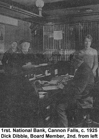 Black and white newspaper photograph of the First National Bank of Cannon Falls interior, showing Dick Dibble leaning on the counter, with some bank employees