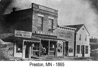 Preston, MN - 1865: Black and white photo of businesses in Preston, MN in 1865